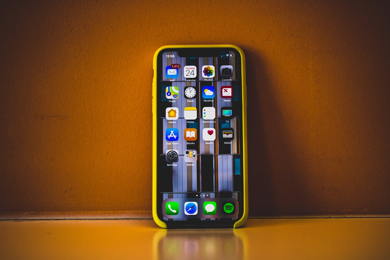 Closeup of an iPhone screen leaning up against a wall