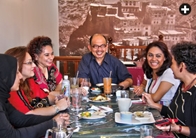 Just down the street, members of the Arab Network of Singapore meet at Zac’s Cafe. Alwi Abu Baker Alkaff sits center, a picture of his community’s Hadhramaut homeland in Yemen behind him.