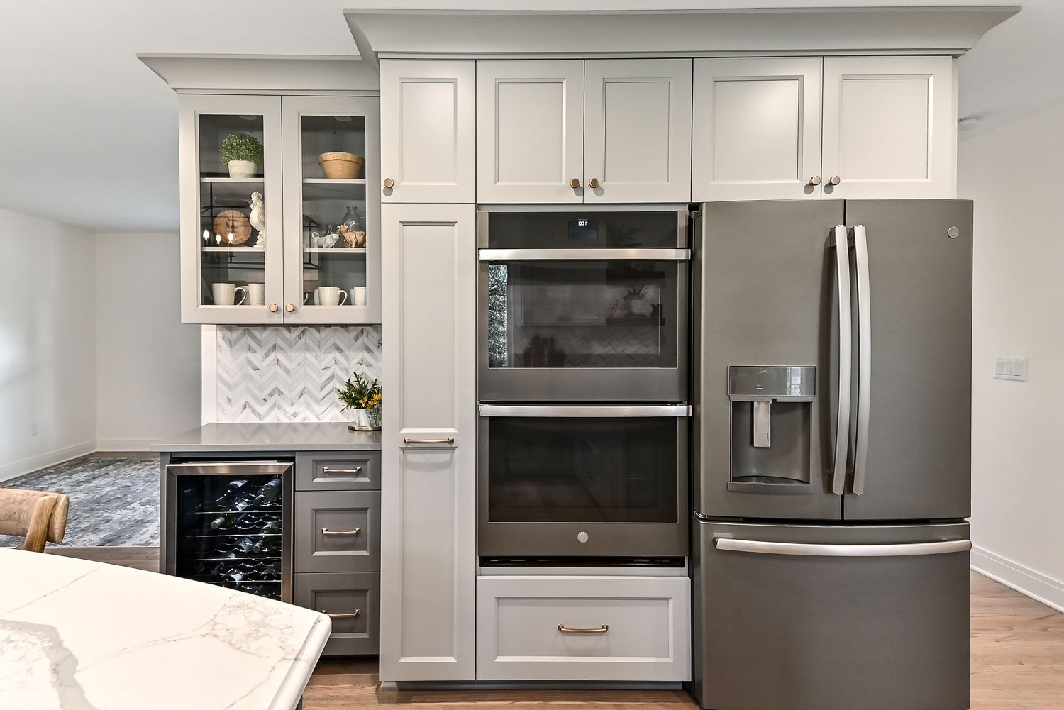 the wall oven next to the refrigerator