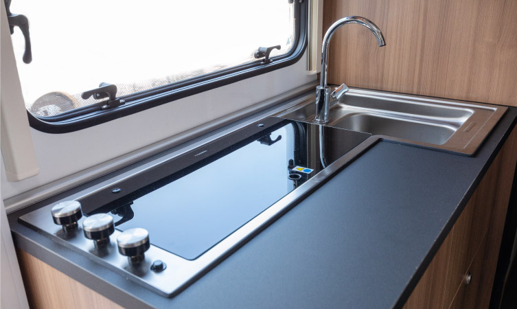 An updated RV kitchen sink and induction stovetop