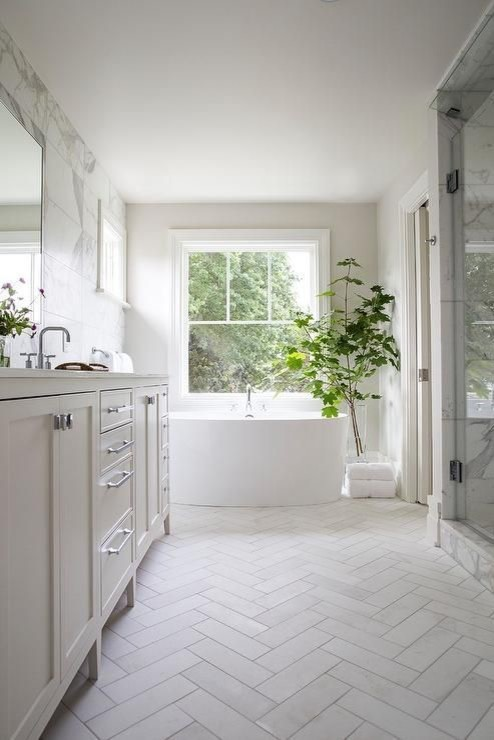 herringbone tile pattern adds sophistication in bathroom