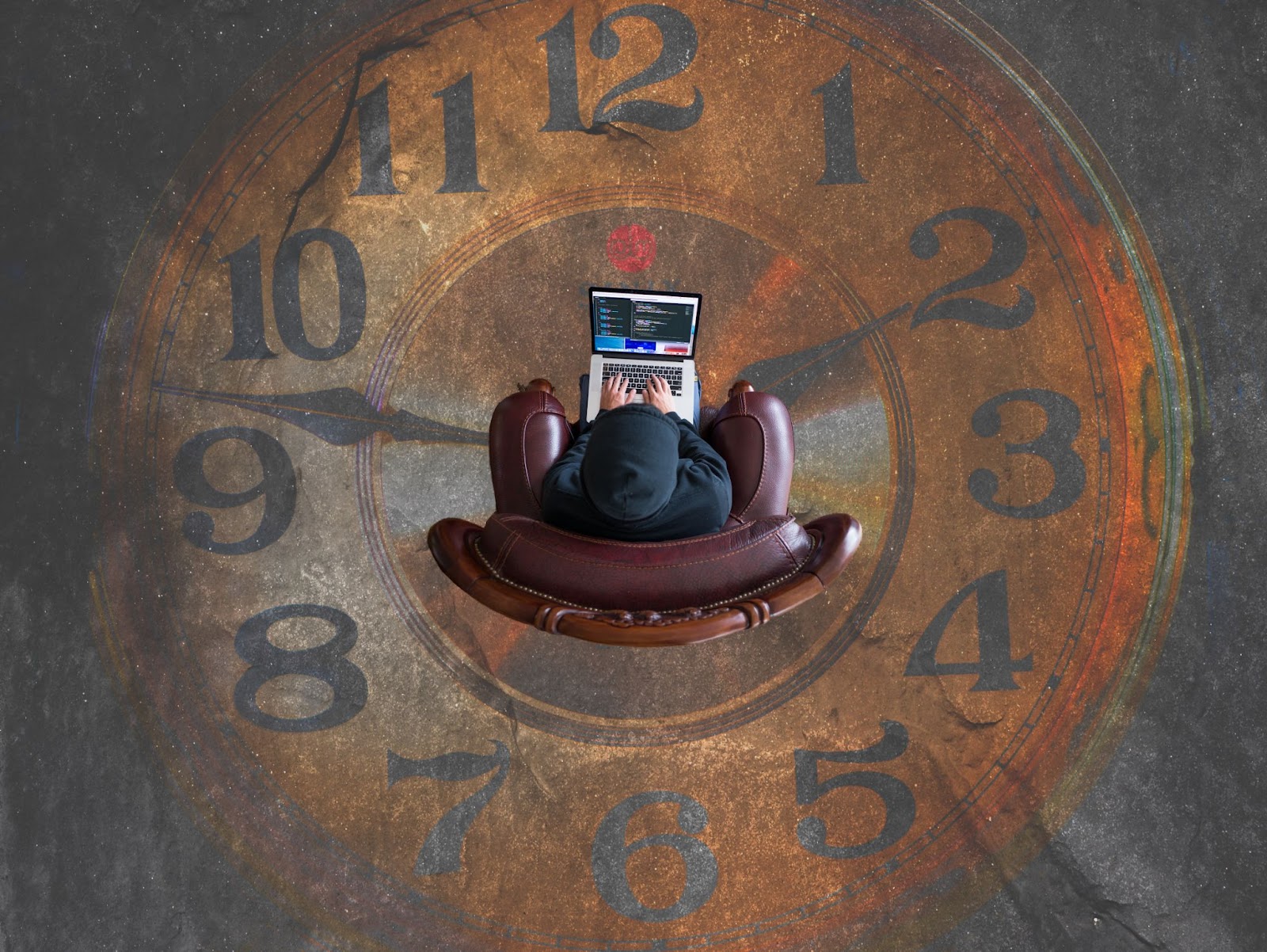 Person working in a chair positioned inside a clock