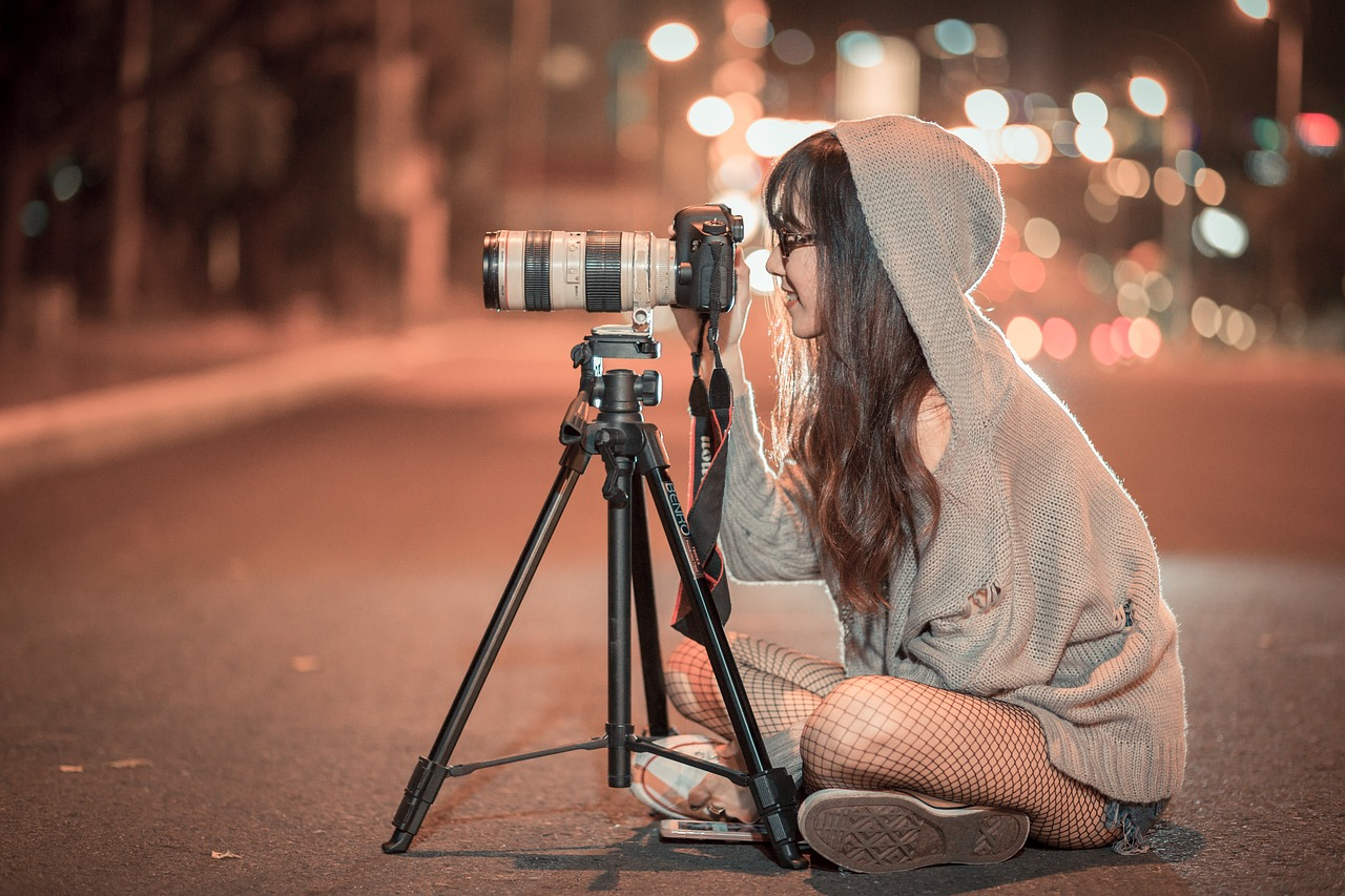 woman taking photos while sitting in the street