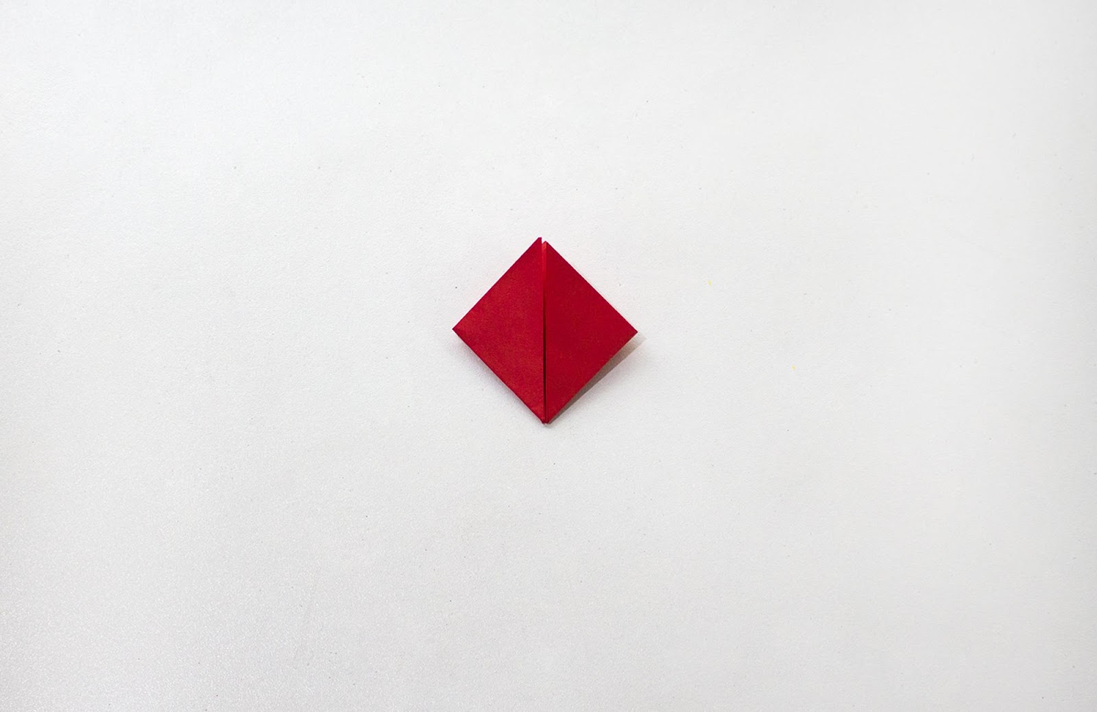 Red sheet of paper folded into a diamond