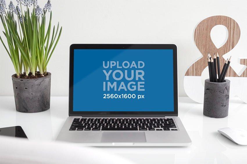 https://cms-assets.tutsplus.com/cdn-cgi/image/width=850/uploads/users/1631/posts/32231/image/Mockup%20of%20a%20MacBook%20Pro%20Placed%20on%20a%20White%20Work%20Desk%20and%20Next%20to%20a%20Plant%20Pot%20copy.jpg