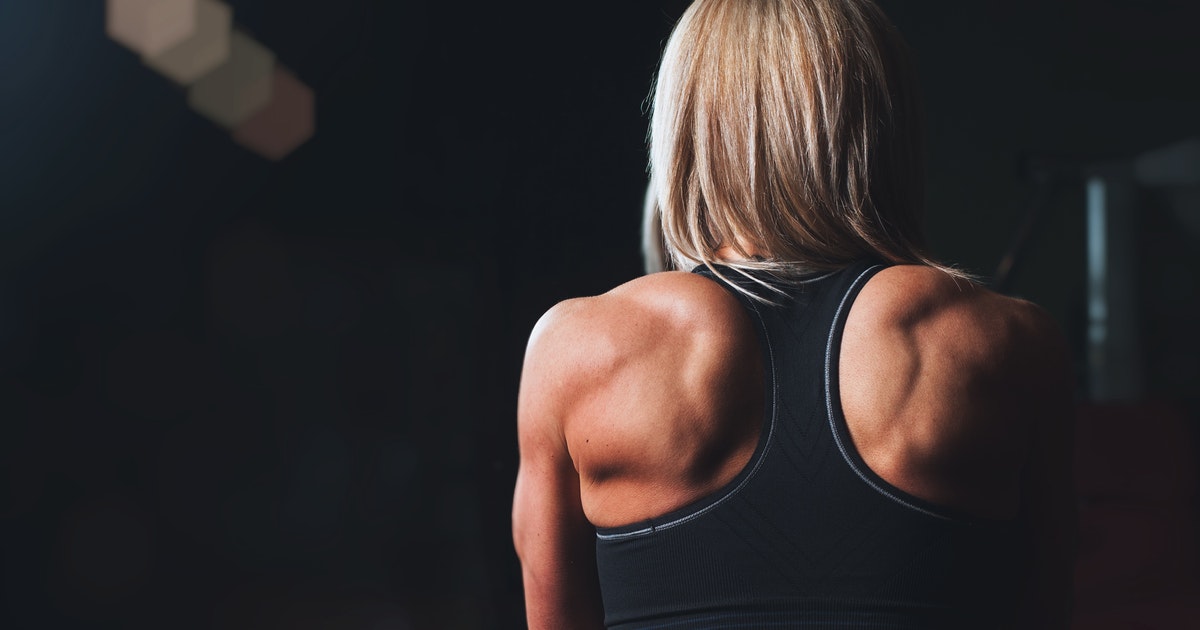 Woman wearing tank top with back muscles 