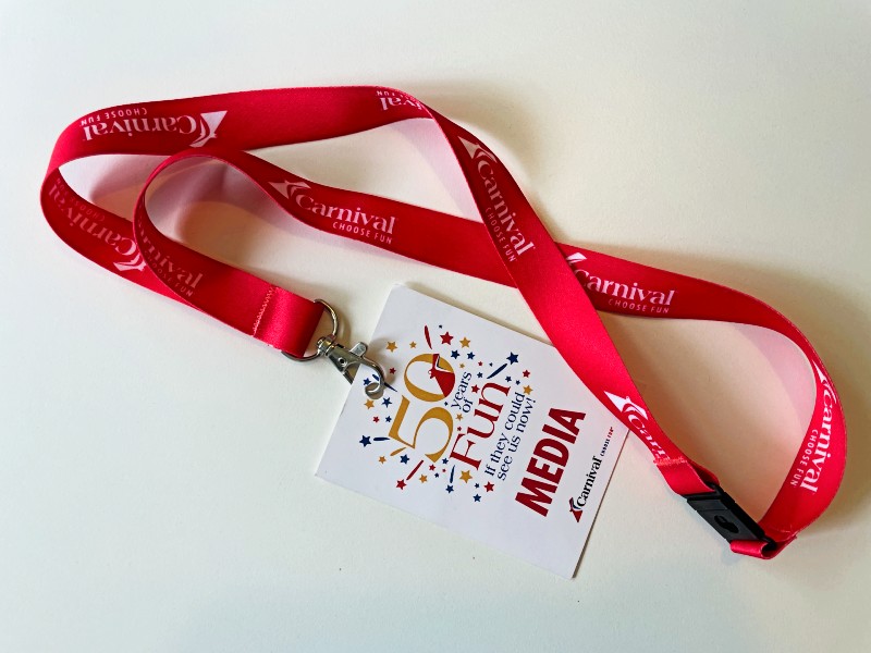 A red carnival cruise lanyard connected to a media pass