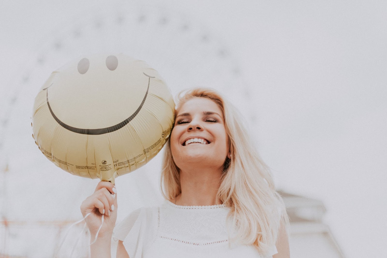 Why is Smiling good - Woman smiling with Balloon