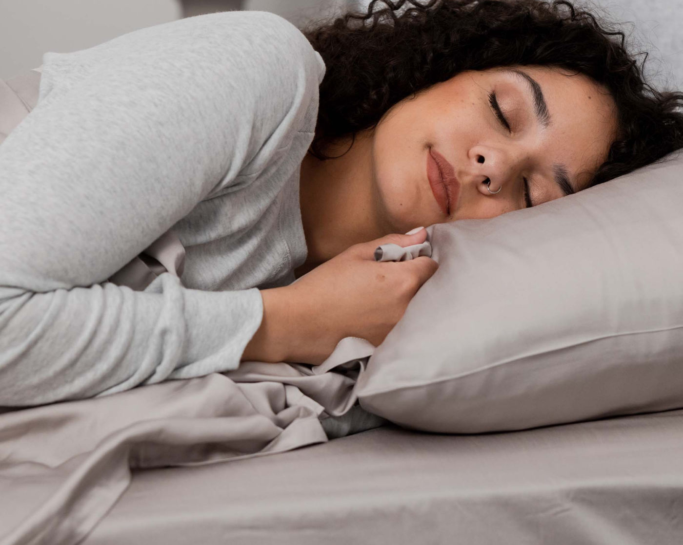 Woman sleeping peacefully in gray Hush Sheets