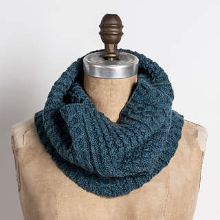 dark teal cable knit cowl on dress form