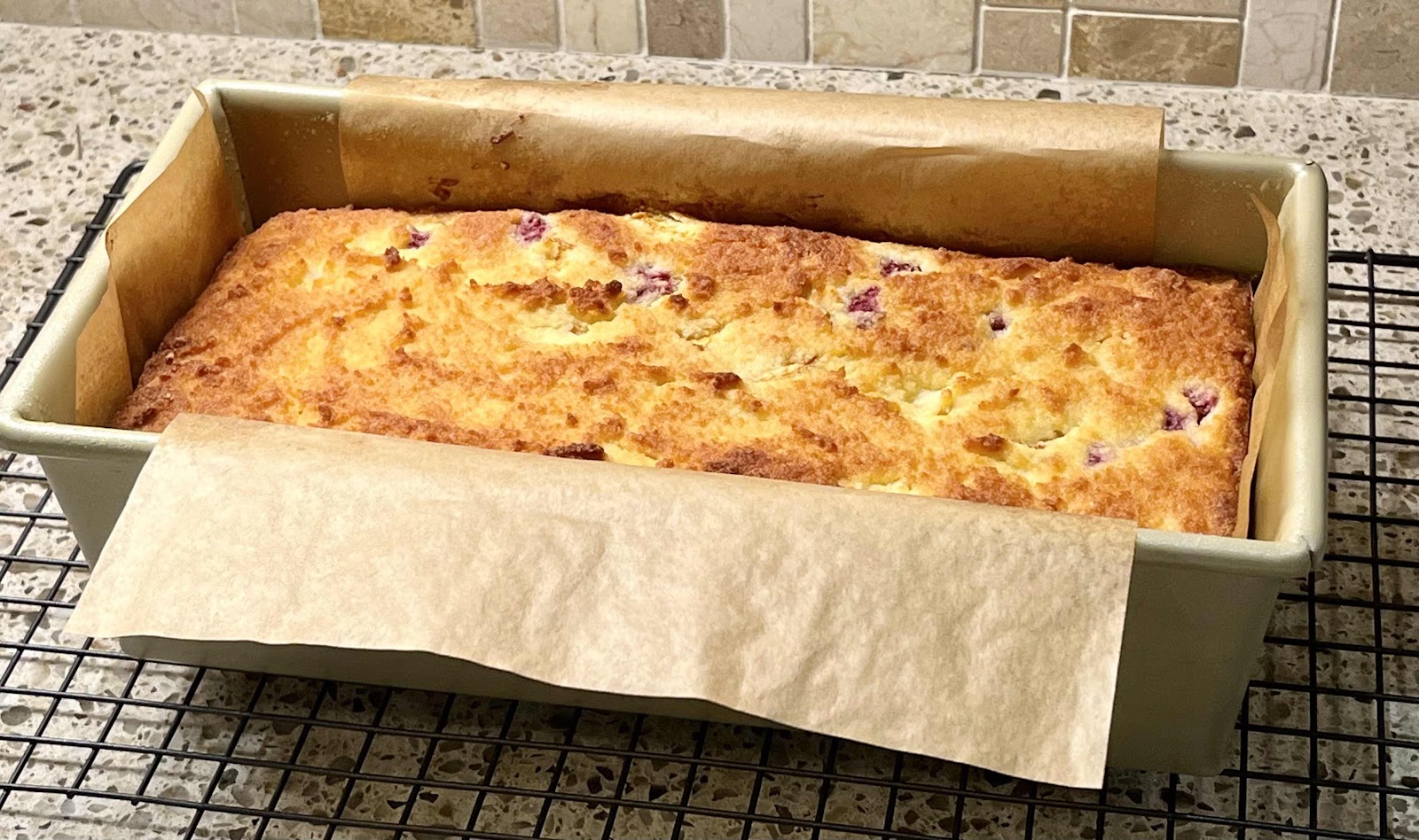Loaf Cake in pan with parchment paper sling