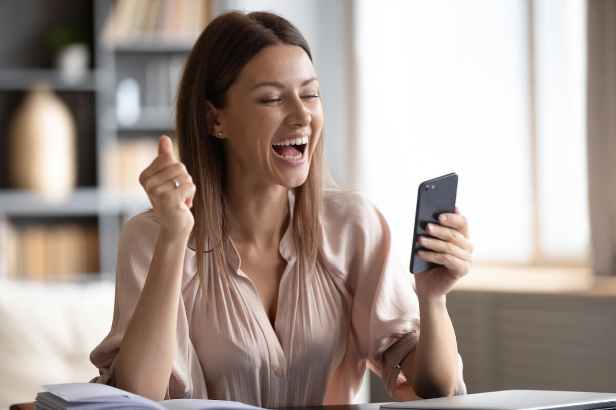 Woman happily looking at her phone