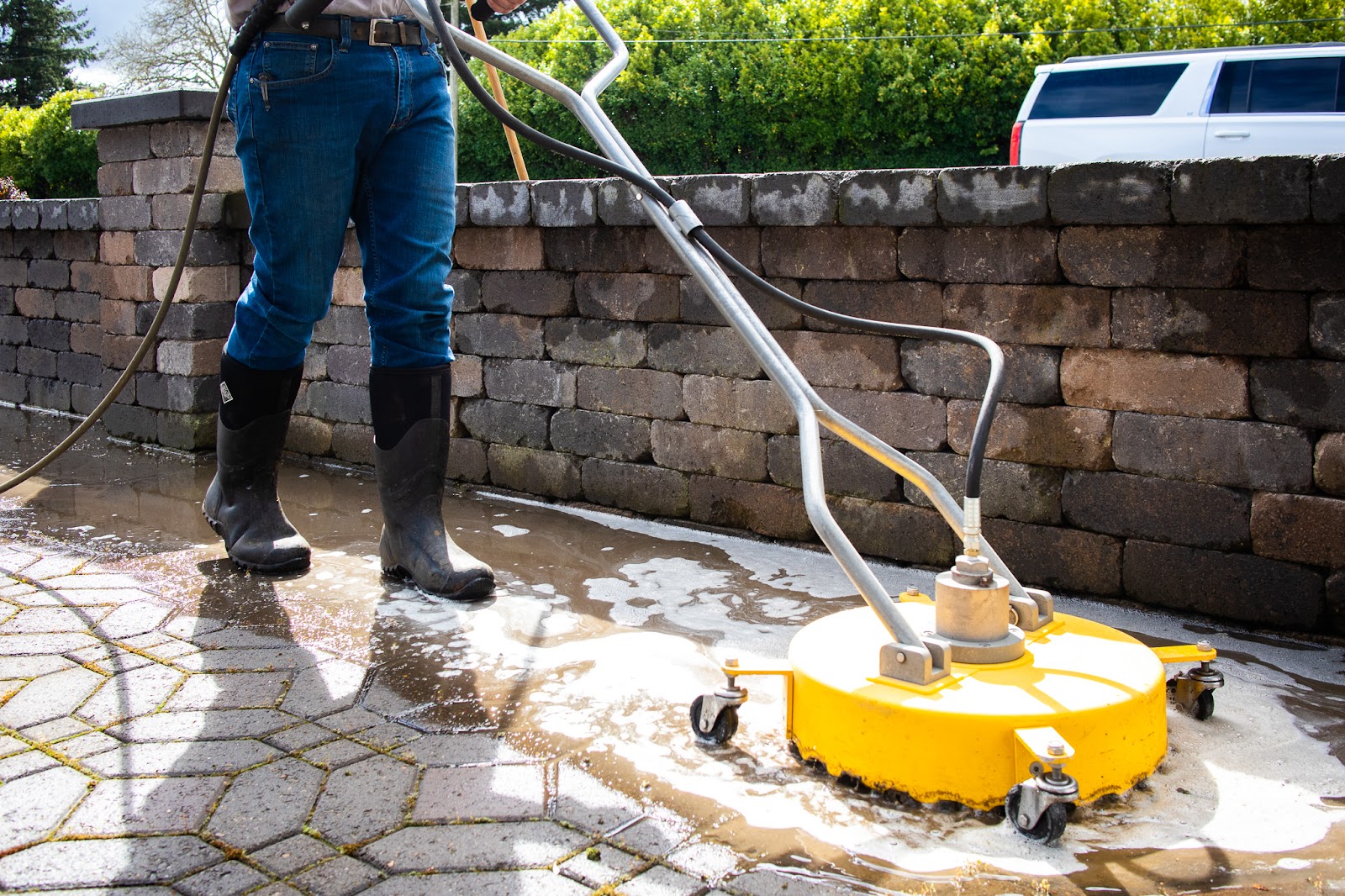 Surface cleaner washing paving stones of dirt and moss