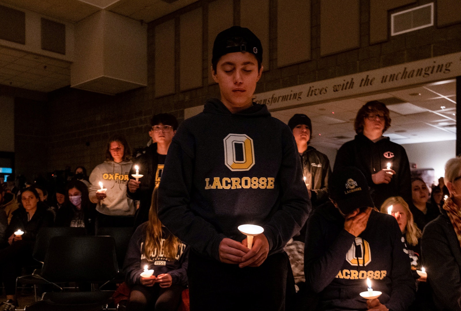 High school students stand during a prayer vigil at Lake Point Community Church in Oxford, Mich., Nov. 30, 2021. A 15-year-old student opened fire at his high school in Oxford, killing three students and wounding eight others. The suspect, who was not named, was taken into custody without incident, police said. (CNS photo/Seth Herald, Reuters)