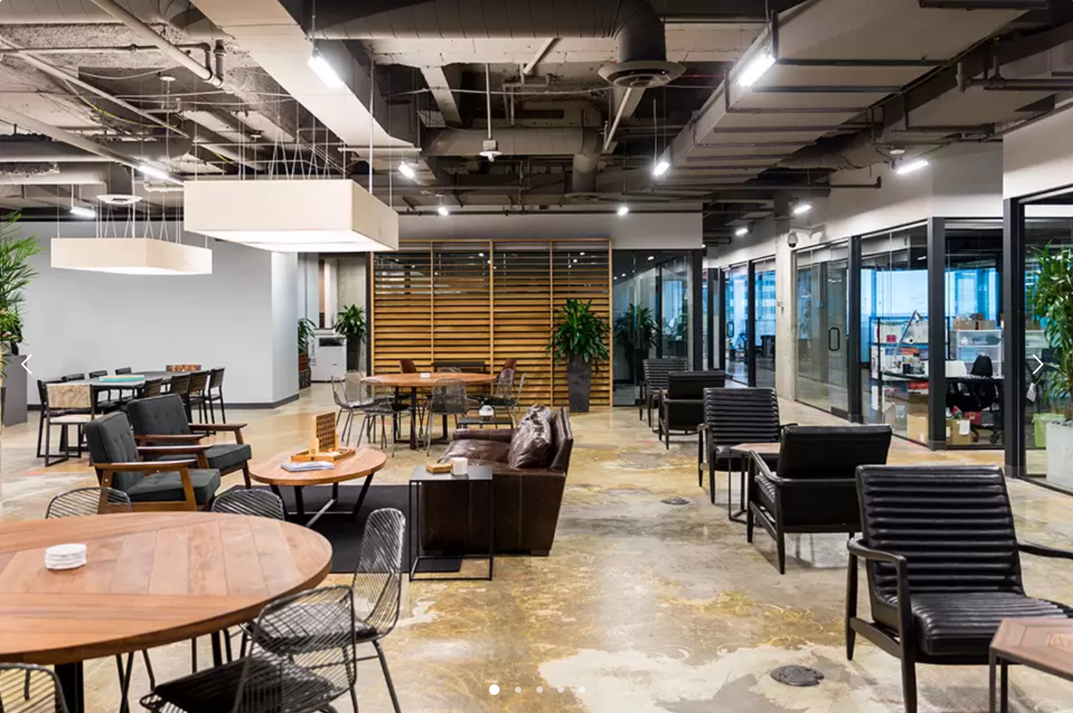 empty coworking space with individual workstations and a lounge area for conversations or collaborative work