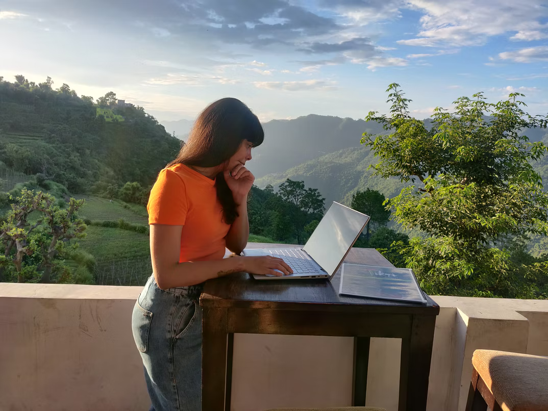 woman stand outside in front of a laptop