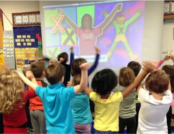 Children watching cartoons dancing on screen and imitating them