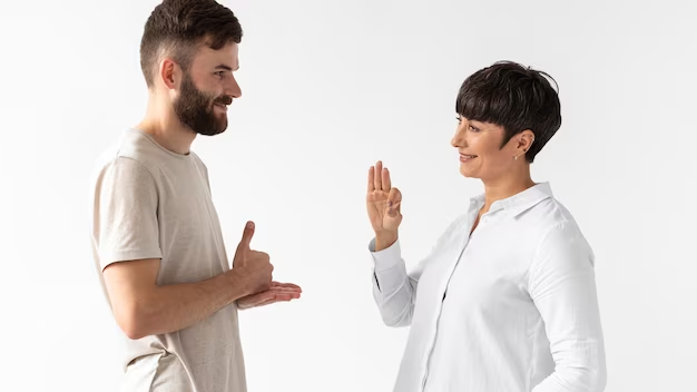 man woman communicating through sign language