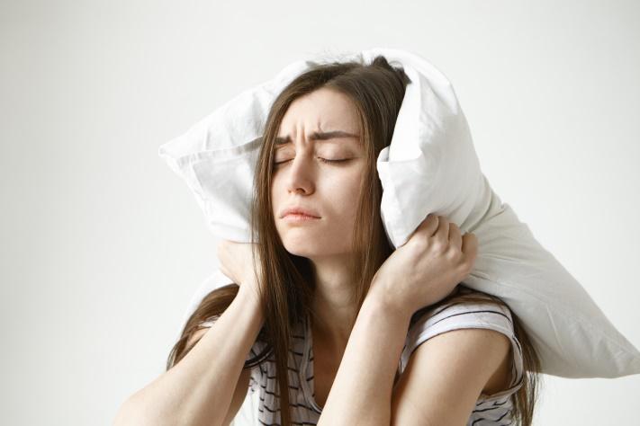 C:\Users\Кристина\Downloads\pretty-student-woman-striped-t-shirt-trying-have-some-sleep-sitting-bedroom-with-pillow-her-head-closing-eyes.jpg