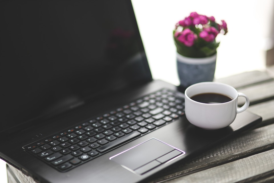 A mug of coffee on a laptop
