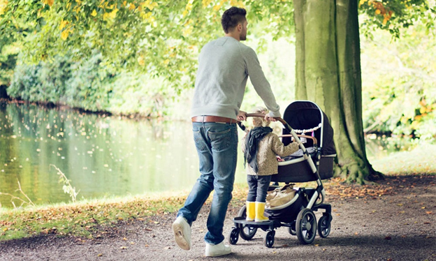 Dad, toddler and baby on a riverside stroll