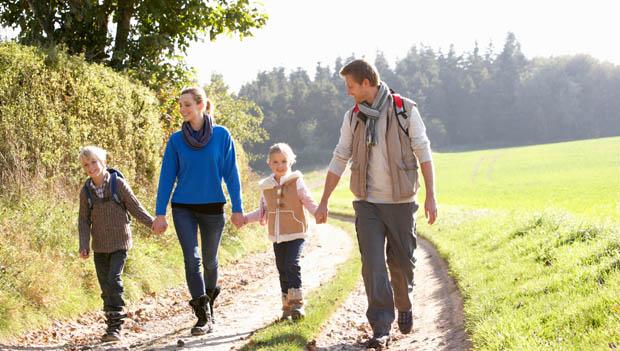 A group of people walking on a dirt path in a field

Description automatically generated with medium confidence