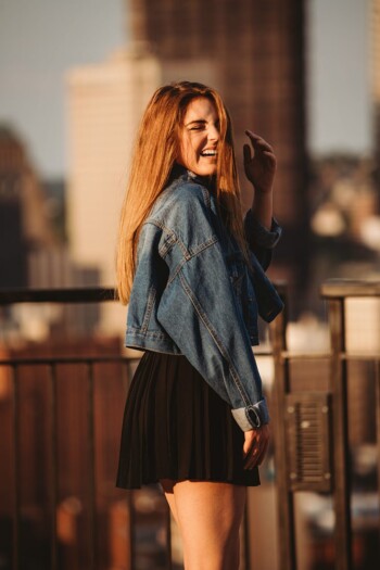 A portrait of a senior girl laughing on Mt. Washington at sunset, Pittsburgh. Portrait by Laura Mares Photography, Pittsburgh Senior Photographer