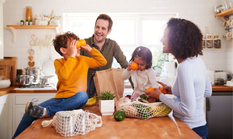 A family unpacking groceries from reusable grocery bags