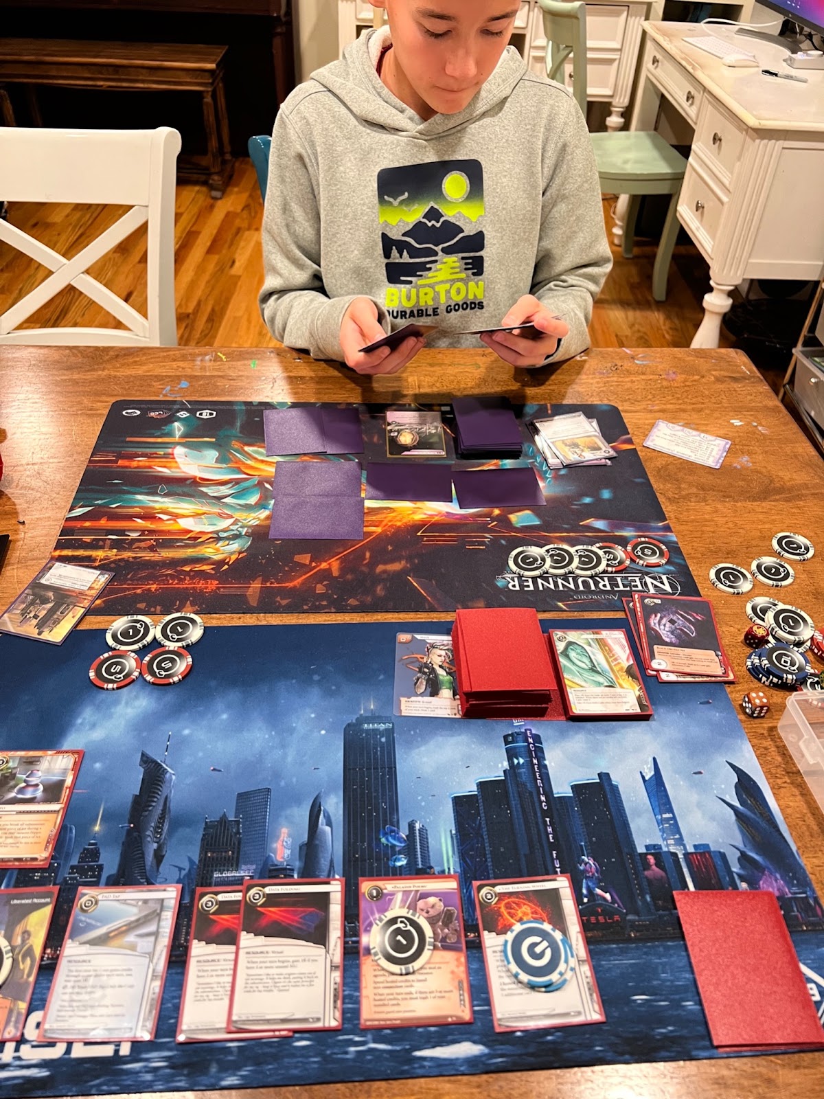 Kevin playing Netrunner with his son.