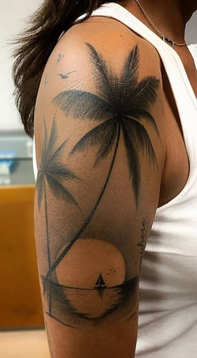 Full view of guy rocking a palm tree tattoo on his shoulder