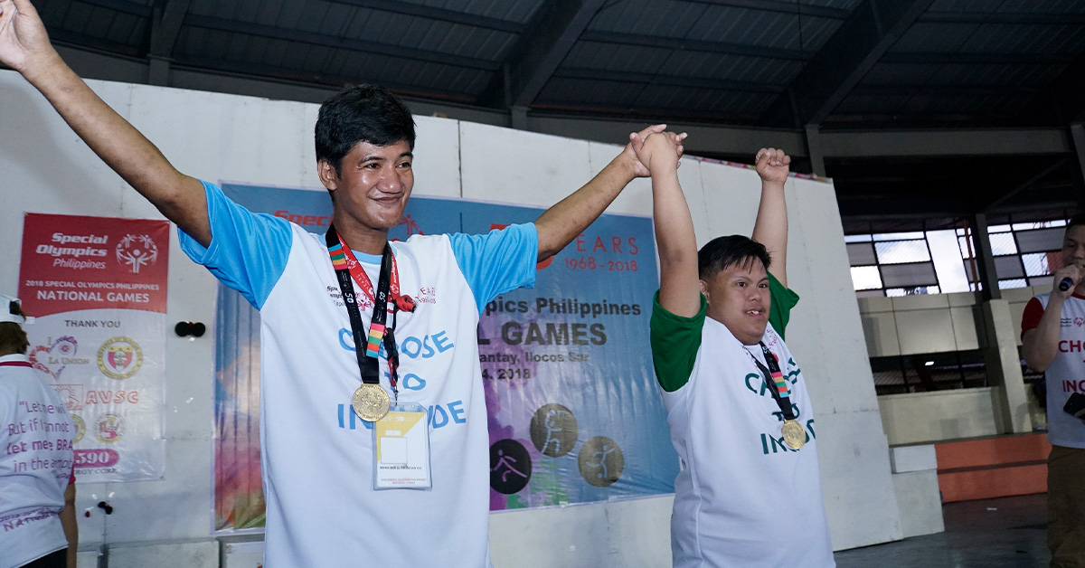 Athletes with intellectual disabilities posing after receiving their medals