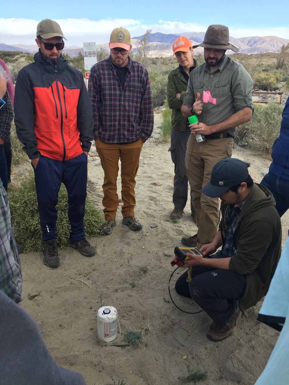 Volunteers gather near Thousand Palms Canyon to listen to a demonstration of how to install and set up the seismic instruments they are about to deploy.