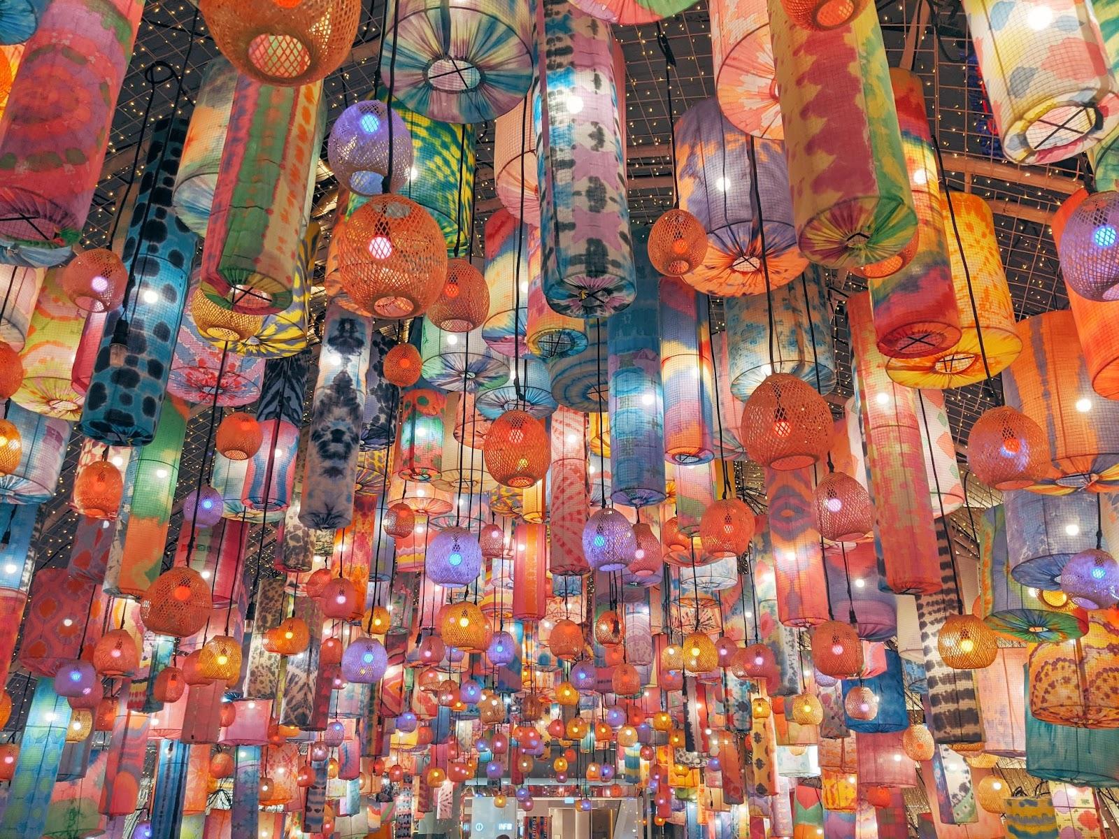 a large amount of paper lanterns in a variety of colours floating