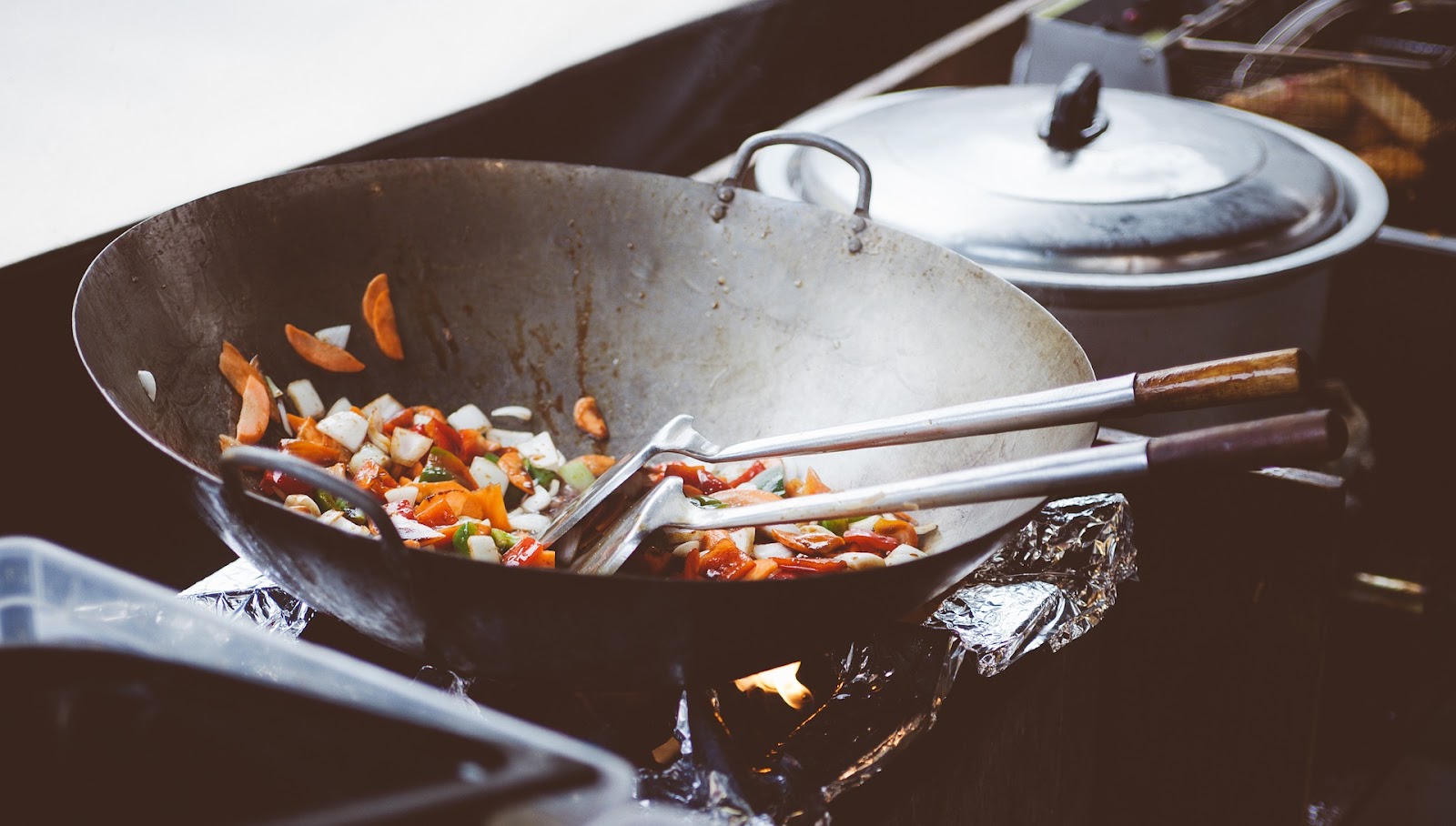 Close up of a wok and stove representing the challenges of content marketing for food