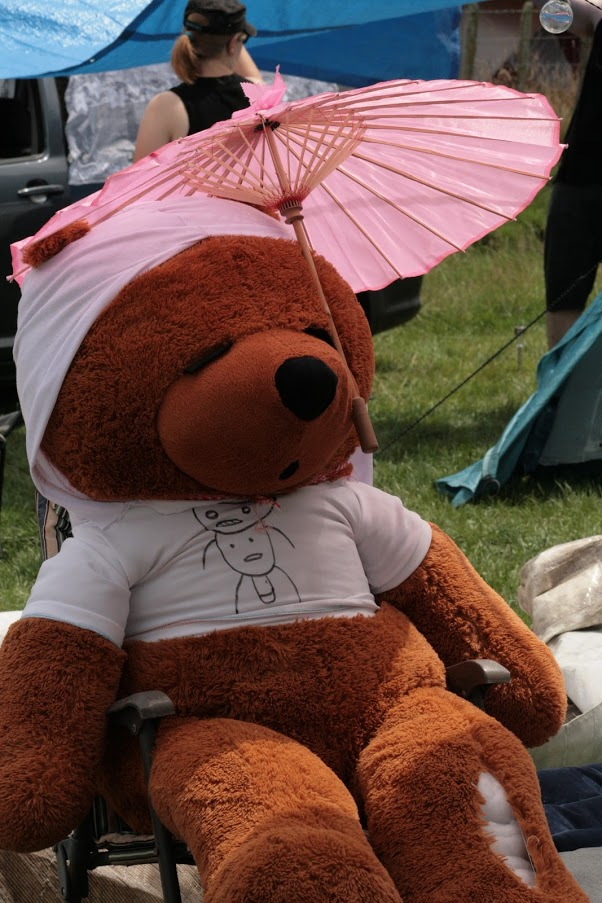 Teddy bear with umbrella.