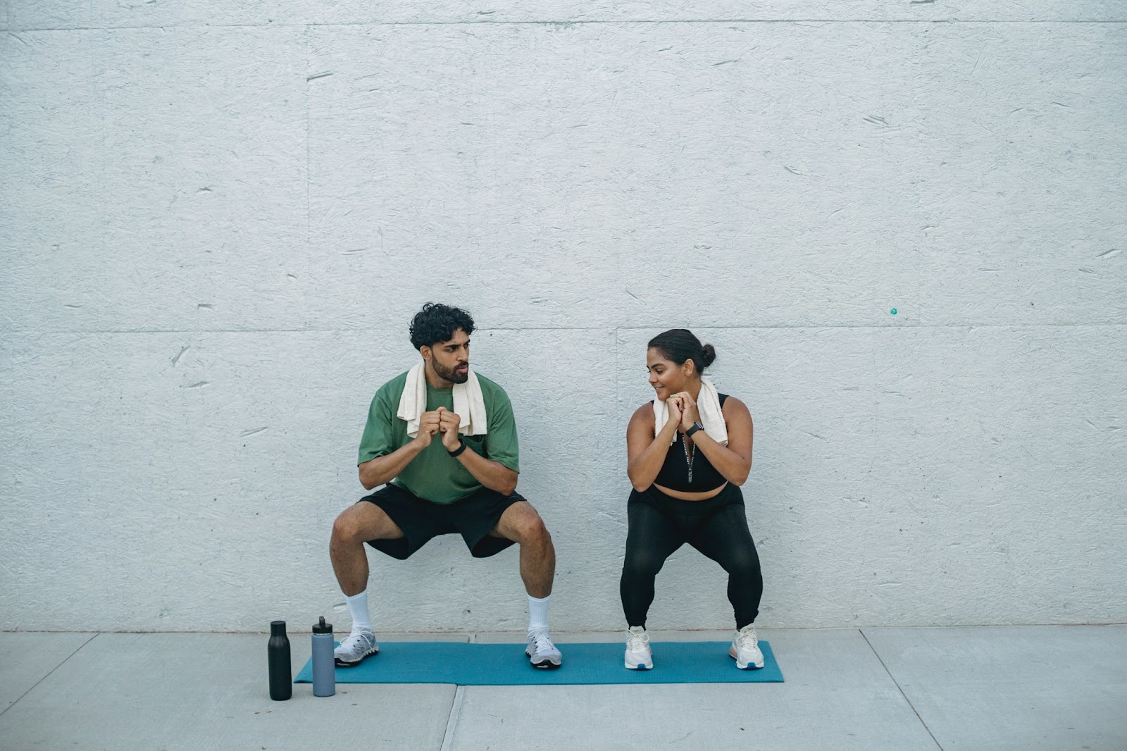 Couple Squatting in Home Gym