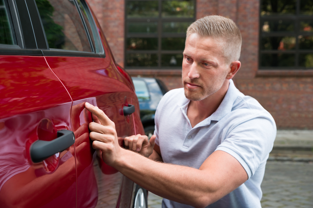 A young man smiling after he no longer needed to sell his car privately as Weelee helped him.