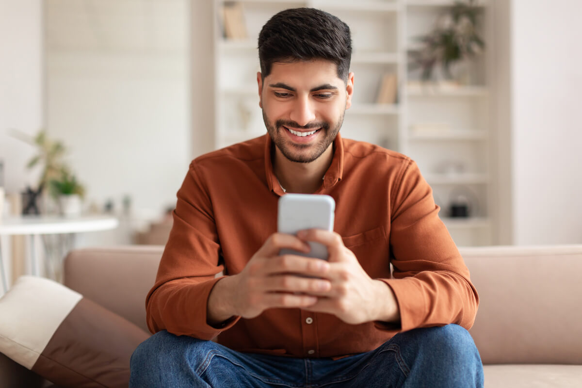 Man happily using a phone