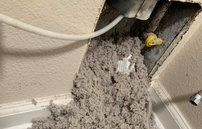 lint being cleaned out of a dryer vent