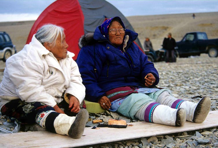 Inuit elders eating muktuk (raw whale skin and blubber).