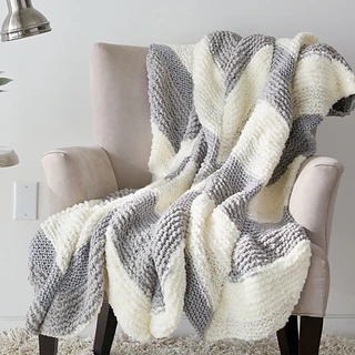 cream and gray knitted chevon blanket on chair