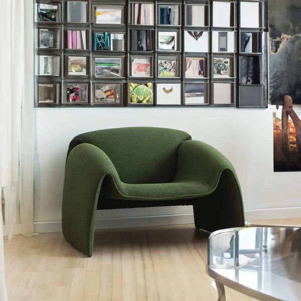 A green accent chair with fabric upholstery and high-density foam.
