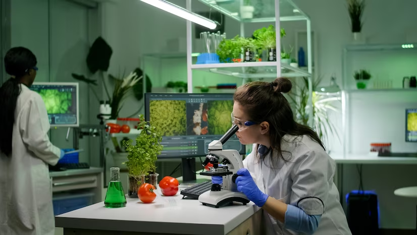 Biologist analyzing a biological slide with a microscope. 