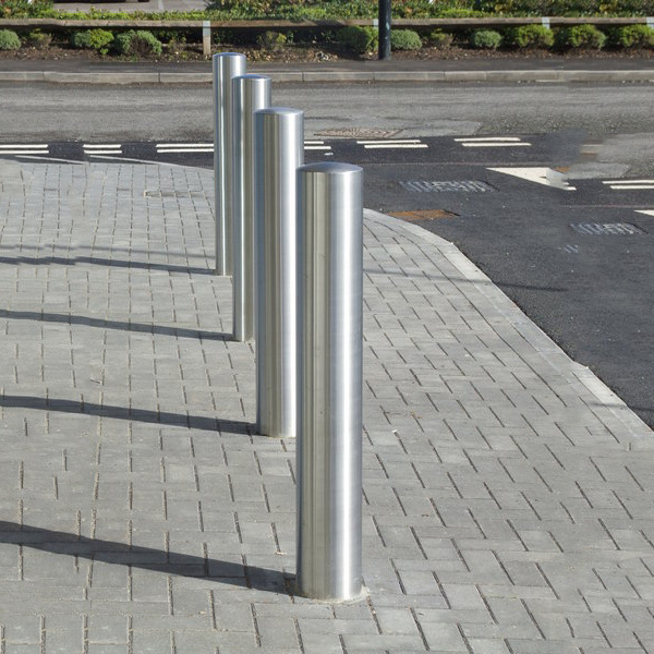 Stainless steel bollards from Barriers Direct in a contemporary design along the side of a public road.