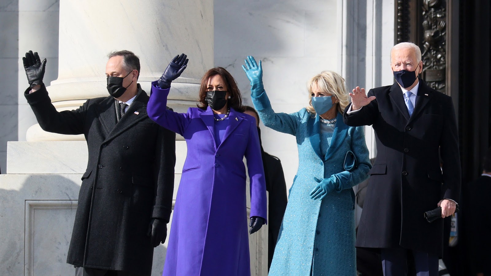 From left to right, Doug Emhoff, Kamala Harris, Jill Biden, and Joe Biden waving on inauguration day.