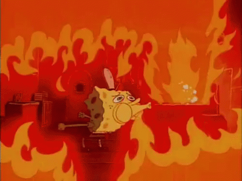 SpongeBob SquarePants trying to blow out a fire on the griddle that's engulfing the whole room in flames.