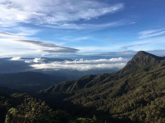 High lush mountain ranges with the highest peak sitting above the clouds at Chingaza National Park in Colombia.