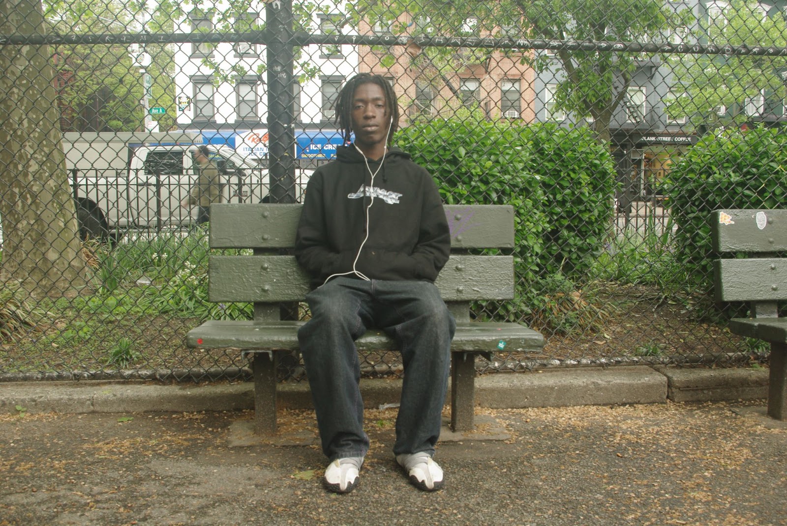 Boy sitting on a park bench.