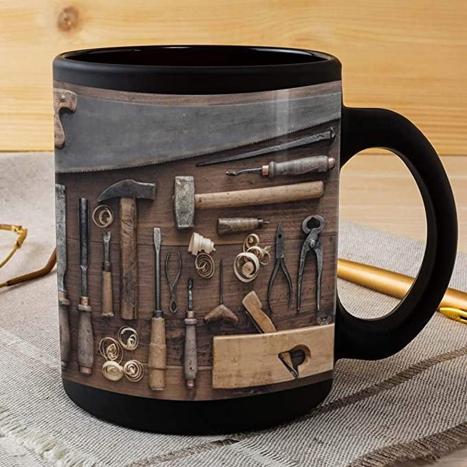 A mug with imagery of various tools laying on a wooden table.