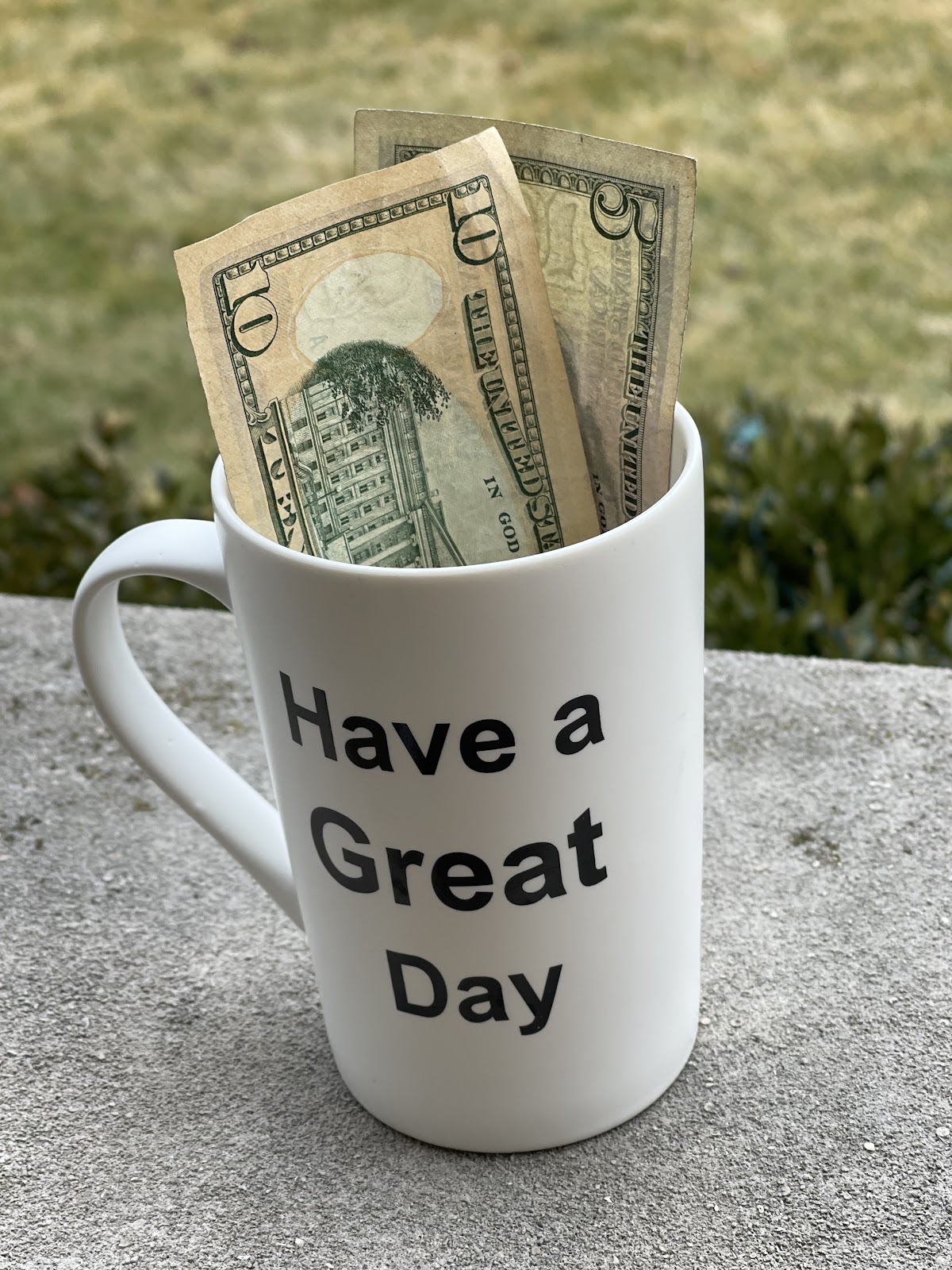money in a coffee mug that says 'have a great day' as a gift for stay at home mom 